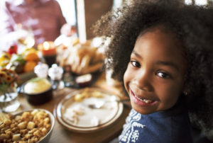 Little girl smiling at the dinner table